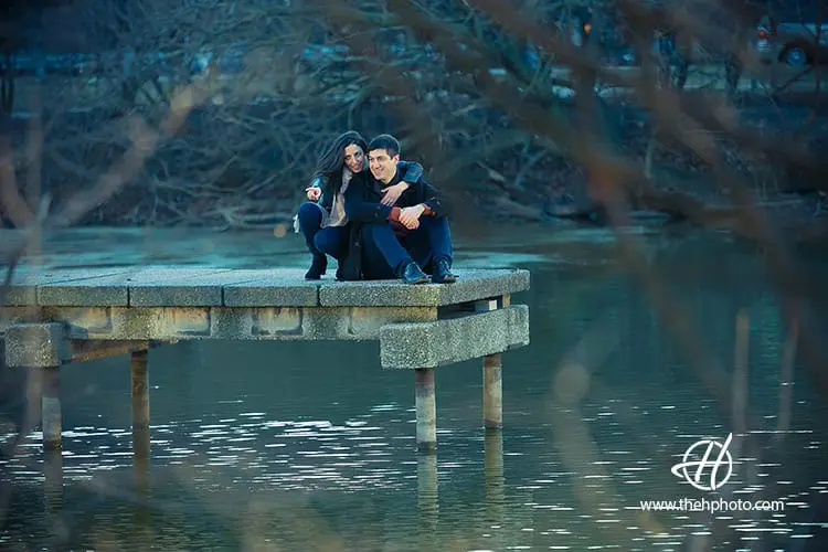 engage couple sitting on the pier