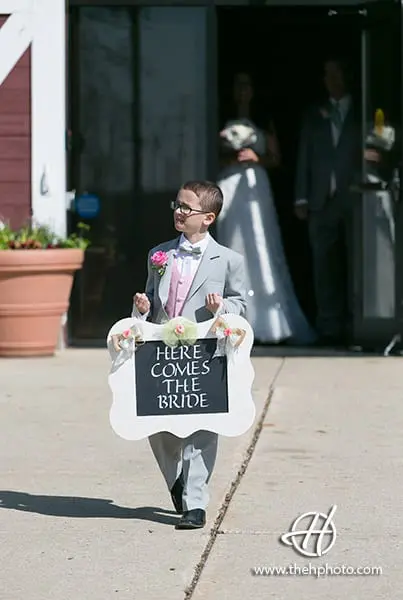 groom's nephew carrying the sign