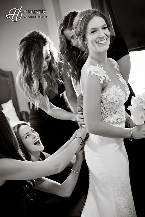 bridemaid helping the bride