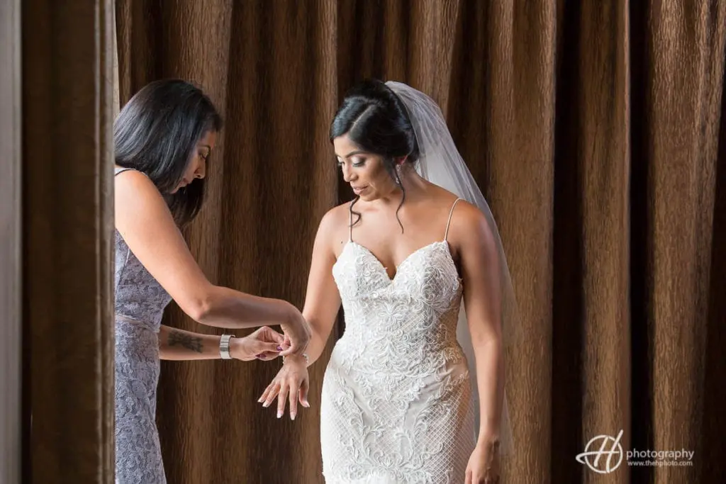 Maid of honor helping Tanya getting ready. bride-getting-ready