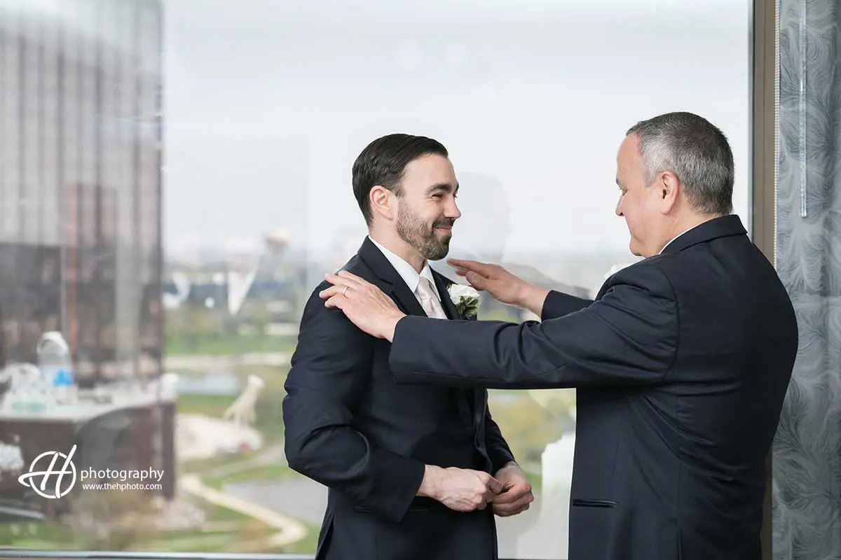 father of the groom helping