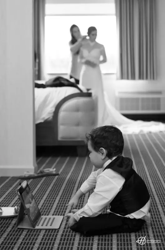 Kid playing on a tablet while Mary got ready. getting ready