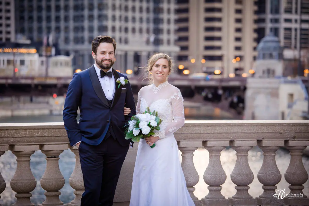 Mary and John posing by the Chicago River. Wedding