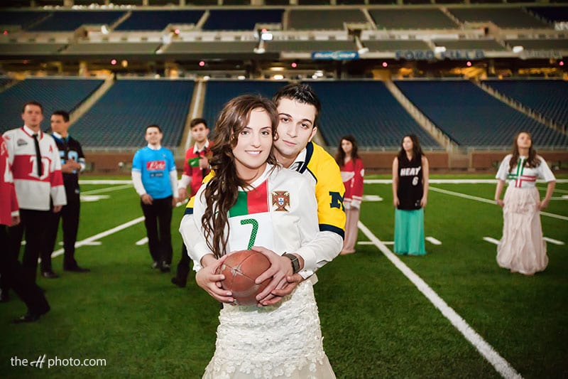 bride and groom playing footbal on Lions Detroit