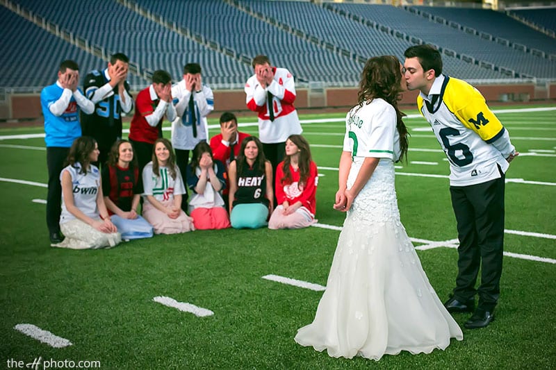 bride and groom kissing on the Detroit stadium