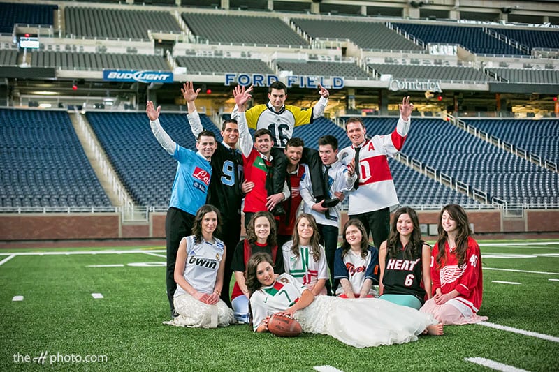 bridal party posing on Ford Field Detroit Stadium