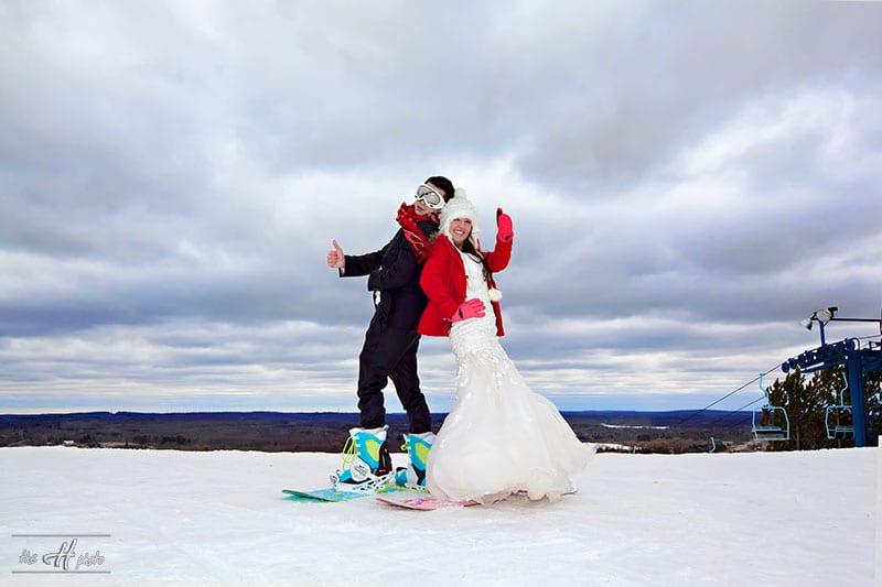 bride and groom having photo post session on snowboards