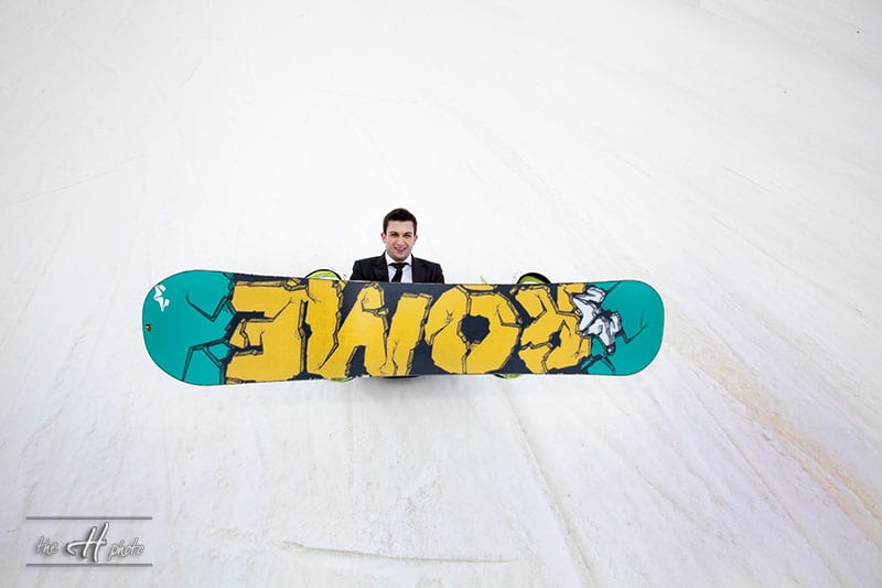 Adrian playing the snowboard for photo shoot on snow