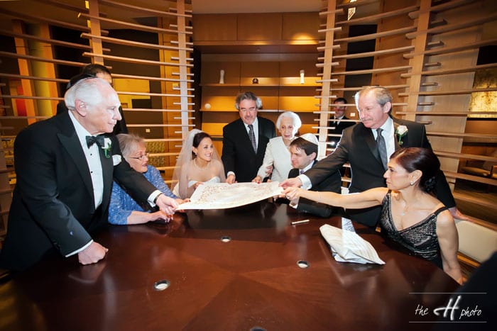 parents, raby and groom with bride holding ketubah