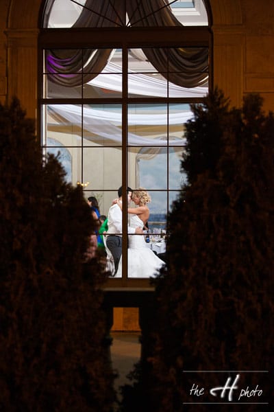 amazing shot with bride and groom dancing seen it from the venue window