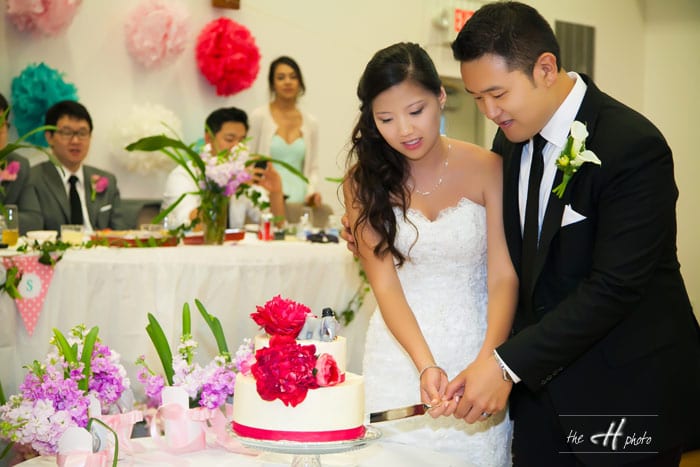 bride and groom cutting the wedding cake