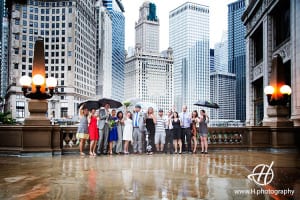 Bridal party taking photos in the rain in Chicago at Magnificient Mile