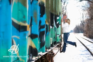 Maureen and Brad playing around the train car for their engagement session 