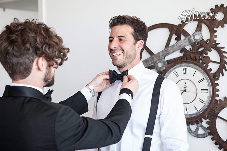 best man helping the groom to get ready 