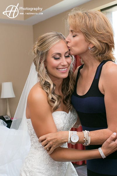 mom kissing bride 