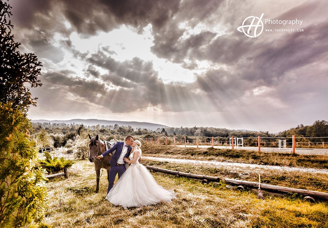 Dramatic image with bride groom and horse.