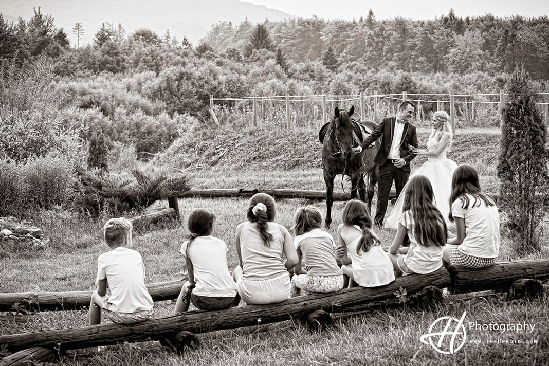 Fun photo with bride and groom by horse.