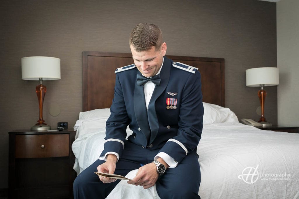Airforce groom reading the letter from the bride