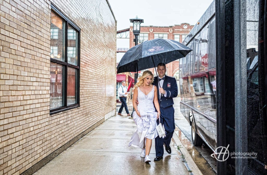 bride and groom in rain