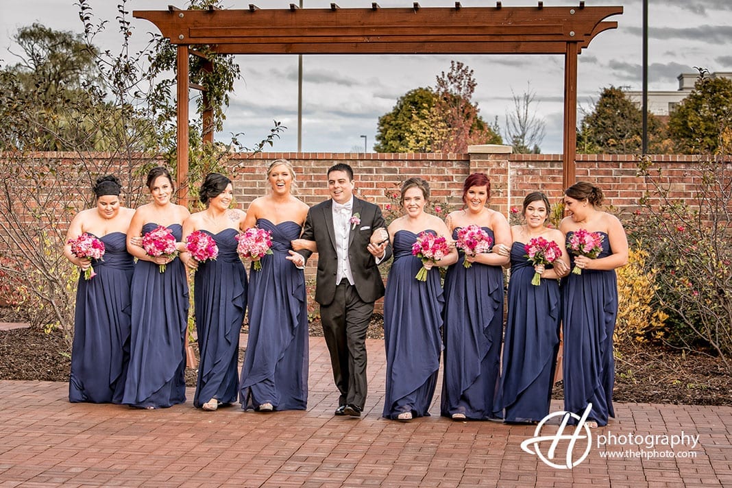 Anthony posing with the bridesmaids.
