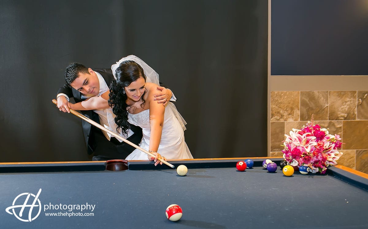 Anthony teaching the bride how to play pool.