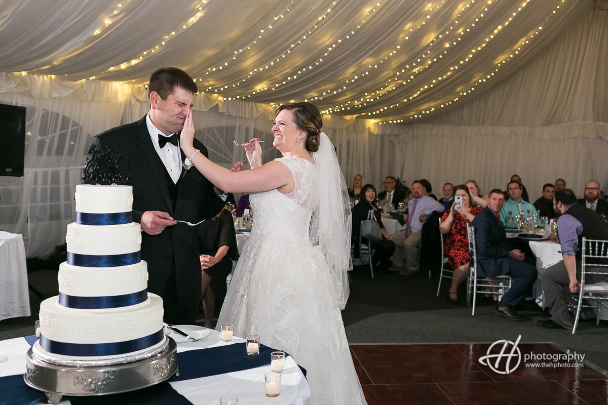 Smashing cake on groom's face.
