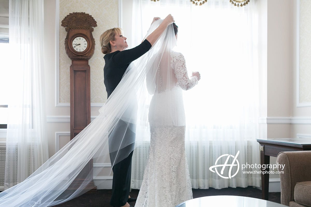 Mother helping the bride with the veil.