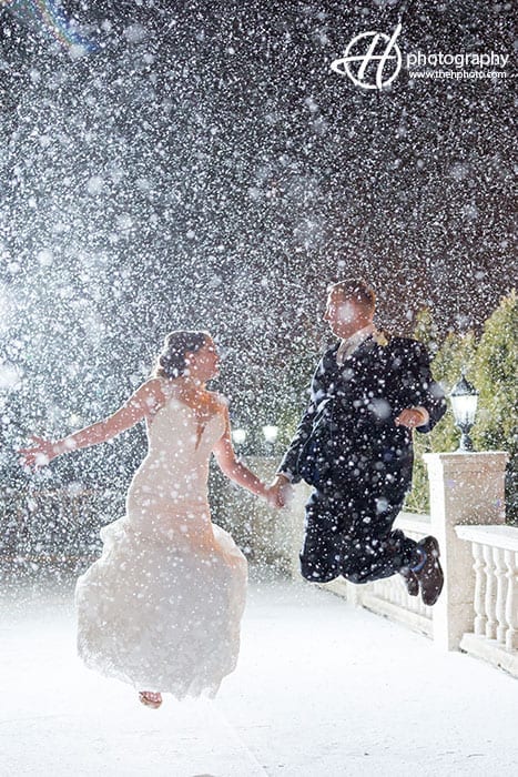 couple making a jump in snow